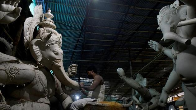 Artist  Krunal Patil amid his work. (Anshuman Poyrekar/HT Photo) 
