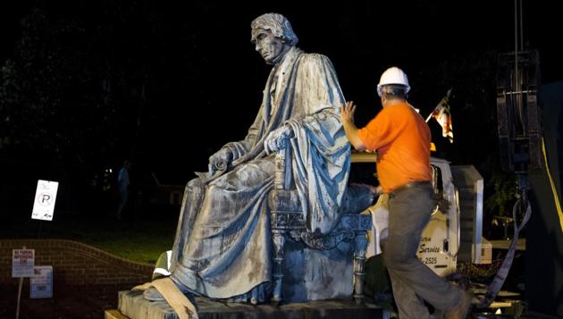 Workers put the monument dedicated to US Supreme Court Chief Justice Roger Brooke Taney on a flatbed truck after it was removed from outside the Maryland State House, in Annapolis, Maryland, on Friday. (AP) Workers put the monument dedicated to US Supreme Court Chief Justice Roger Brooke Taney on a flatbed truck after it was removed from outside the Maryland State House, in Annapolis, Maryland, on Friday. (AP)