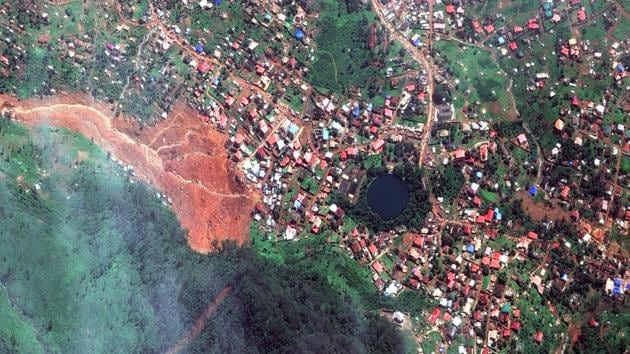 A satellite image of the mudslide (C, left), in Freetown, Sierra Leone shows the scale of the damage. About 1.9 hectares (4.7 acres) of the hillside collapsed on Monday, which covered homes in a 3.6 hectare (8.9 acres) area. Fresh estimates from aerial surveillance show a 29.1 hectares (71 acres) area that is likely to collapse as the country expects more rain in coming days. (DigitalGlobe via AP)