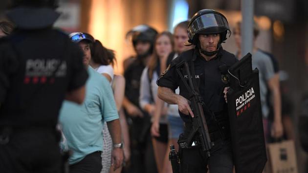 Spanish policemen stand guard in a cordoned off area after a van ploughed into the crowd, killing 13 persons and injuring over 80 on the Rambla in Barcelona. (AFP Photo) Spanish policemen stand guard in a cordoned off area after a van ploughed into the crowd, killing 13 persons and injuring over 80 on the Rambla in Barcelona. (AFP Photo)