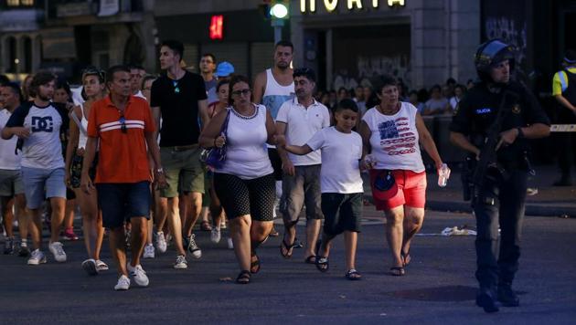 People are escorted by Spanish policemen outside a cordoned off area after a van ploughed into the crowd, killing 13 people and injuring over 80 on the Ramblas in Barcelona on August 17, 2017. (AFP Photo) People are escorted by Spanish policemen outside a cordoned off area after a van ploughed into the crowd, killing 13 people and injuring over 80 on the Ramblas in Barcelona on August 17, 2017. (AFP Photo)