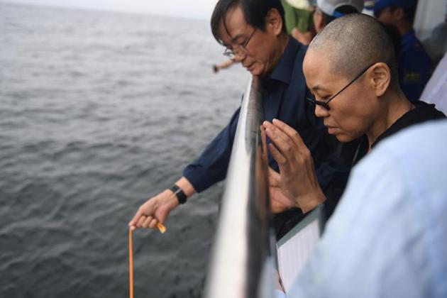 Nobel laureate Liu Xiaobo's wife Liu Xia praying as Liu's ashes are buried at sea on July 15, 2017. (AFP) Nobel laureate Liu Xiaobo's wife Liu Xia praying as Liu's ashes are buried at sea on July 15, 2017. (AFP)