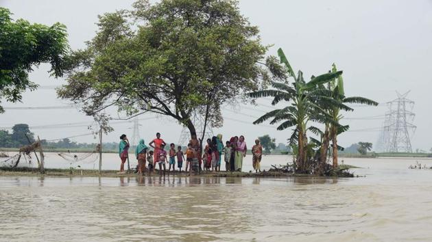 Villagers stand on a strip of land surrounded by floodwaters in Purnia district in Bihar on Friday. (AFP) Villagers stand on a strip of land surrounded by floodwaters in Purnia district in Bihar on Friday. (AFP)