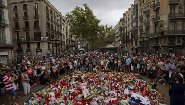 People pay their respect at a memorial tribute of flowers, messages and candles to the victims on Barcelona's historic Las Ramblas promenade on the Joan Miro mosaic, embedded in the pavement where the van stopped after killing at least 13 people in Barcelona. (AP Photo) People pay their respect at a memorial tribute of flowers, messages and candles to the victims on Barcelona's historic Las Ramblas promenade on the Joan Miro mosaic, embedded in the pavement where the van stopped after killing at least 13 people in Barcelona. (AP Photo)
