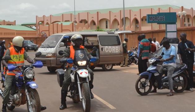 Police officers wait near the hearse carrying the body of a man killed during the attack at the Aziz Istanbul Turkish restaurant in Ouagadougou, before a ceremony on August 17, 2017 (AFP) Police officers wait near the hearse carrying the body of a man killed during the attack at the Aziz Istanbul Turkish restaurant in Ouagadougou, before a ceremony on August 17, 2017 (AFP)
