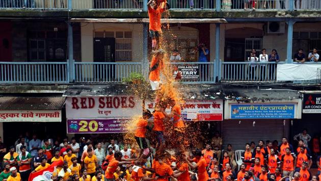 A devotee breaks a clay pot containing curd as others form a human pyramid during celebrations to mark the Hindu festival of Janmashtami in Mumbai. (Danish Siddiqui/REUTERS)