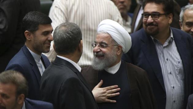 Iranian President Hassan Rouhani, center, leaves the parliament after his speech in a session to debate his proposed cabinet, in Tehran, Iran, Tuesday, Aug. 15, 2017. (AP) Iranian President Hassan Rouhani, center, leaves the parliament after his speech in a session to debate his proposed cabinet, in Tehran, Iran, Tuesday, Aug. 15, 2017. (AP)
