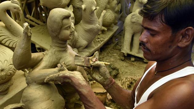 Making idols using clay is much more laborious compared to plaster which is quick to dry, but mitigates their impact once immersed into water bodies. Plaster of Paris idols make use of hemi hydrated calcium sulphate and don’t dissolve or disintegrate as easily, affecting coastal and riverine ecology. (Mohd Zakir / HT Photo)