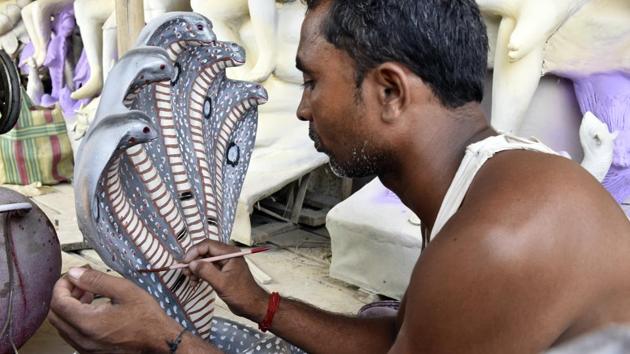 The implementation of the 2016 demonetization caused setbacks to idol makers’ revenues with buyers cash strapped and prices of raw materials increasing. The recent Goods and Services Tax (GST) implementation has also led to idols being sold at a higher price this year. While small idols range in the ₹500-1000 range the larger, more ornate pieces can fetch up to ₹20,000. (Mohd Zakir / HT Photo)