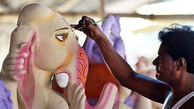 As the festive season picks up in India during the second half of the year beginning with Ganesh Chaturthi, idol makers get busy with orders pouring in months in advance. As demand for idols of Durga, Ganesh and other deities spikes upwards, artisans move closer to the national capital in search of work. A peek into the multi-stage process of crafting these festive icons. (Mohd Zakir / HT Photo)