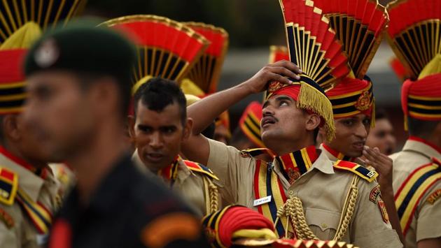A soldier adjusts his headgear during the full-dress rehearsal for the 71st Independence Day celebrations at the Red Fort in New Delhi on August 13 (Money Sharma/AFP)