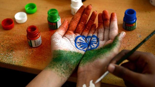 A student has their hand painted with the Indian national flag at an event to celebrate Independence Day on August 15, 2017, in Chennai.(AFP Photo)
