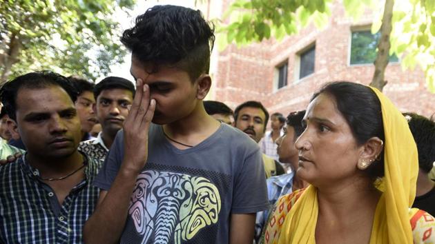 Aditya, son of Rishi Pal ,with other family members. Rishi Pal died while cleaning sewer at Lok Nayak Hospital on Sunday. Family members claimed that Pal was never given any protective gear by any contractor.