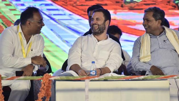 (L-R front row) Dinesh Gundurao, Congress vice president Rahul Gandhi and Karnataka Chief Minister Siddaramaiah shares a light moment during a public meeting at National College ground in Bengaluru, India, on Wednesday (Arijit Sen/HT Photo)