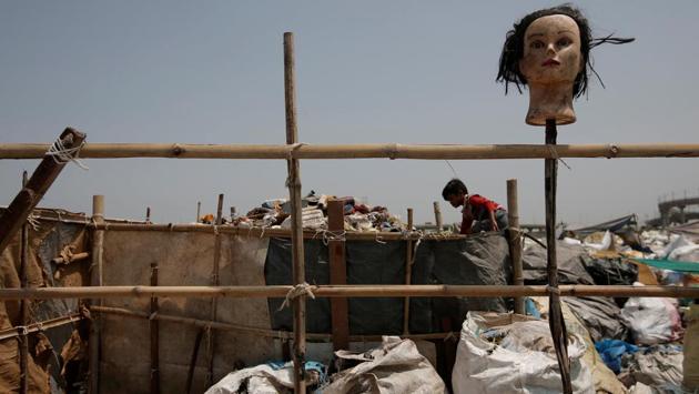 A boy picks out plastic bottles at a recycling yard in New Delhi on August 18. (Adnan Abidi/REUTERS)
