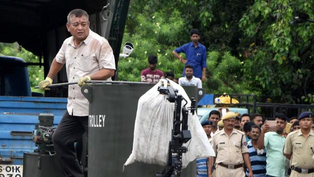 A bomb squad of the Assam Police transporting a suspected IED from the Guwahati rail station before detonating it on Friday.(HT PHOTO)