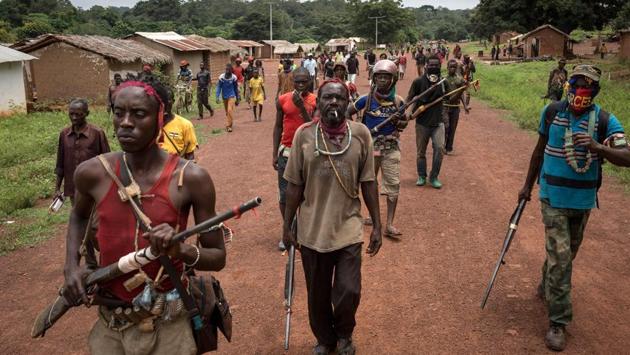 Antibalaka fighters walk in Gambo, southeast Central African Republic, on August 16, 2017. Antibalaka fighters fought against a Seleka militia to chase them out of Gambo in early August. (Alexis Huguet/AFP)