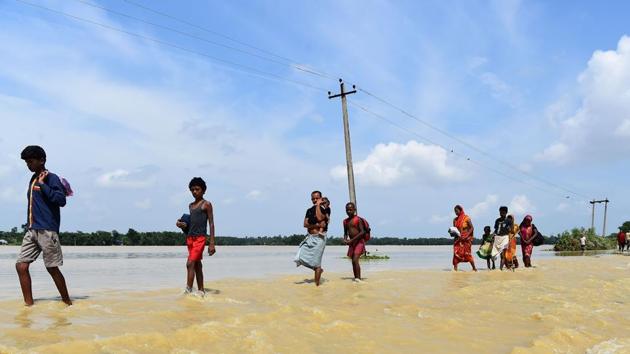 Nepali people make their way through flood waters in Tilathi Village in Saptari District in Kathmandu, on August 15, 2017. At least 221 people have died and more than 1.5 million have been displaced by monsoon flooding across India, Nepal and Bangladesh. (Prakash Mathema/AFP)