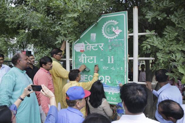 MLA Jewar removes posters from a signage in Greater Noida. MLA Jewar removes posters from a signage in Greater Noida.