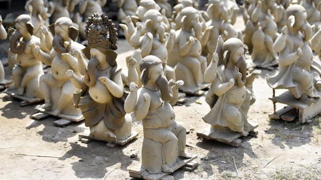 Once the features on the idols have been defined, it is set out to dry in the sun for a couple of days -- a precarious step in the idol making process which falls during the monsoon season and has artisans on alert. The roadside displays during this step are also crucial advertising for the idol makers and attract passersby. (Mohd Zakir / HT Photo)