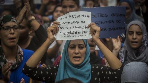 A woman holds a banner reading in Spanish: “I am Muslim and Catalan, not a terrorist. Islam is Peace”, during a protest by the Muslim community to condemn the attacks, in Barcelona, Spain, August 19 (AP) A woman holds a banner reading in Spanish: “I am Muslim and Catalan, not a terrorist. Islam is Peace”, during a protest by the Muslim community to condemn the attacks, in Barcelona, Spain, August 19 (AP)