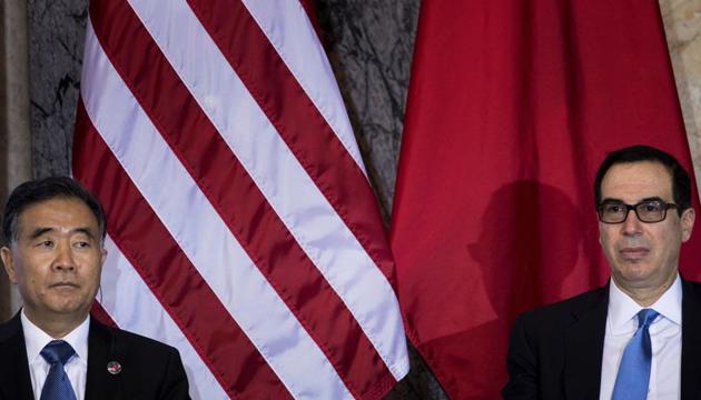 This file photo taken on July 19, 2017 shows Chinese vice premier Wang Yang (L) and US secretary of the treasury Steven Mnuchin during a US and China comprehensive Economic Dialogue at the US Department of the Treasury in Washington, DC. The US on August 22, 2017 slapped sanctions on 16 Chinese and Russian individuals and companies, accusing them of supporting the North Korean nuclear program and attempting to evade US sanctions.(AFP)