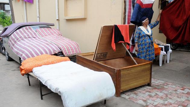 A woman drying wet mattresses in Mohali on Tuesday. (Anil Dayal/HT)