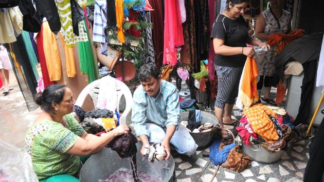 Families attempted to dry their wet clothes on Tuesday. (Anil Dayal/HT)