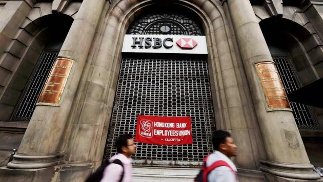 People walk in front of a bank that was closed due to the nationwide bank strike, in Kolkata on Tuesday. (PTI Photo) People walk in front of a bank that was closed due to the nationwide bank strike, in Kolkata on Tuesday. (PTI Photo)