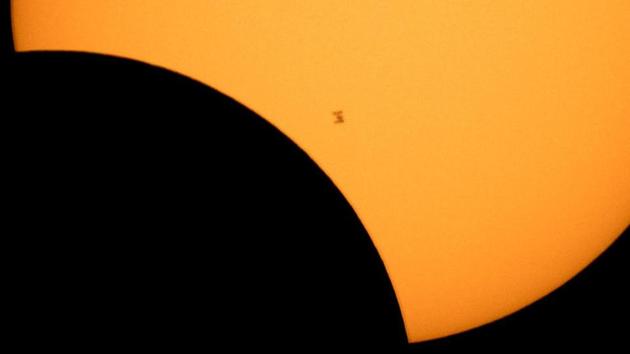 Silhouette of the International Space Station is seen as it transits the sun during a partial solar eclipse in US. (REUTERS)
