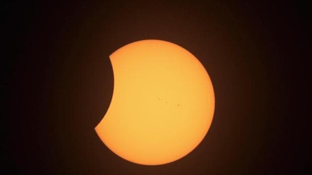 The last glimmer of sun gives way to a momentary sparkle known as the ‘diamond ring’ effect just before the sun slips completely behind the moon, leaving only the aura of its outer atmosphere, or corona visible.The corona, lasting just two minutes marks the peak phase of totality and the only stage of the eclipse safe to view with the naked eye. (Scott Olson/AFP)