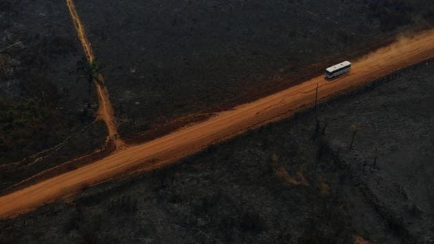 A coach drives along the Trans- Amazon Highway as it passes through deforested and burnt land during ‘Operation Green Wave’ conducted by agents of the Brazilian Institute for the Environment and Renewable Natural Resources, or Ibama to combat illegal logging in Apui, Brazil. (Bruno Kelly/REUTERS)