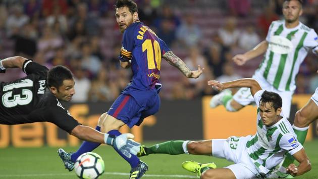 Lionel Messi scores during the Spanish league football match FC Barcelona vs Real Betis at the Camp Nou stadium in Barcelona on August 20, 2017. (AFP) Lionel Messi scores during the Spanish league football match FC Barcelona vs Real Betis at the Camp Nou stadium in Barcelona on August 20, 2017. (AFP)