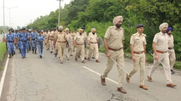 Flag march in industrial area near Chandigarh Railway station on Wednesday morning. (HT Photo)