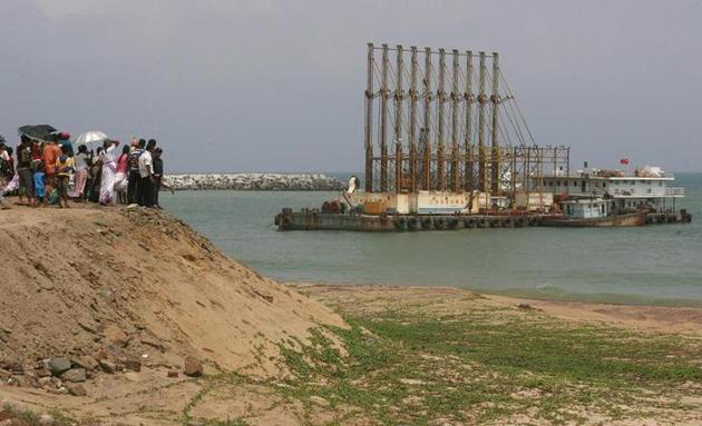 Visitors watch Chinese dredging ships work in Hambantota. (Reuters File) Visitors watch Chinese dredging ships work in Hambantota. (Reuters File)