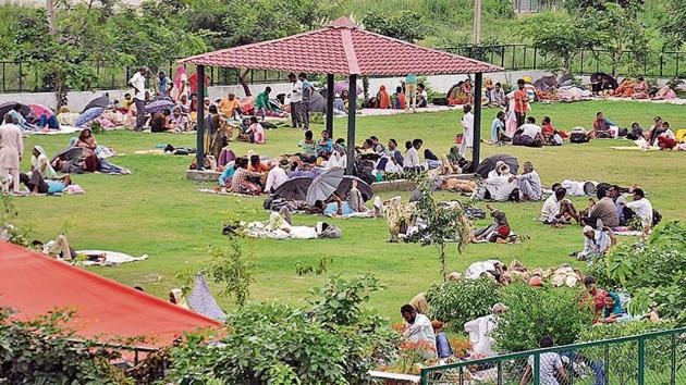 Dera Sacha Sauda followers resting at a park in the sect’s Naam Charcha Ghar in Sector 23, Panchkula, on Tuesday. They have reached here from different parts of the region.(Sant Arora/HT)