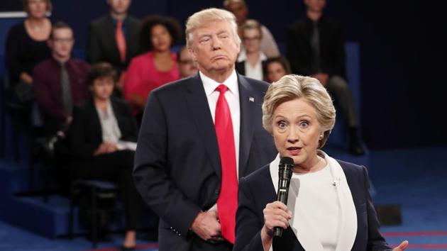 In this October 9, 2016 file photo, Democratic presidential nominee Hillary Clinton speaks as Republican presidential nominee Donald Trump listens during the second presidential debate at Washington University in St Louis. (AP file) In this October 9, 2016 file photo, Democratic presidential nominee Hillary Clinton speaks as Republican presidential nominee Donald Trump listens during the second presidential debate at Washington University in St Louis. (AP file)