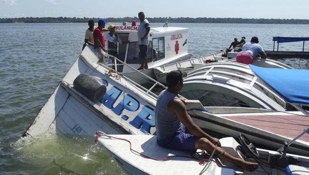 People surround the boat "Comandante Ribeiro" that sank while carrying 70 people during a search and rescue mission in the Xingu River, Para state, Brazil, Wednesday, Aug. 23, 2017. (AP) People surround the boat "Comandante Ribeiro" that sank while carrying 70 people during a search and rescue mission in the Xingu River, Para state, Brazil, Wednesday, Aug. 23, 2017. (AP)