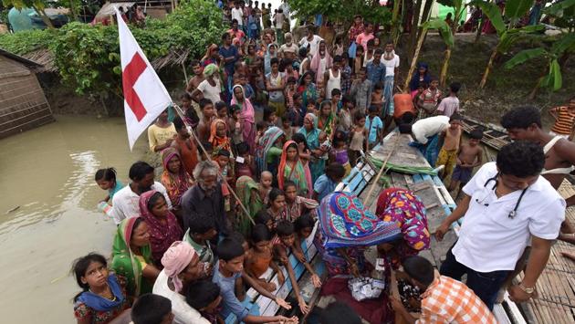 Indian medical officials of the Jhargaon Public Health Centre (PHC) distribute medicines to villagers in the flood affected area of Morigaon district, Assam. Floodwaters have killed at least 154 and displaced more than 14 lakh people so far. (Biju Boro/AFP) Indian medical officials of the Jhargaon Public Health Centre (PHC) distribute medicines to villagers in the flood affected area of Morigaon district, Assam. Floodwaters have killed at least 154 and displaced more than 14 lakh people so far. (Biju Boro/AFP)