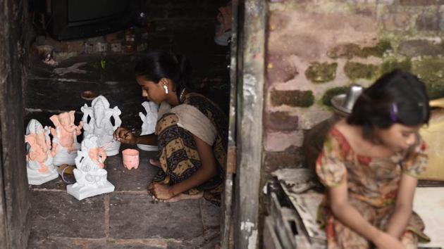 An artist paints miniature idols of Ganesha at a small-scale workshop. Work on the idols begins months in advance with artisans flocking to areas where the festival is celebrated with fervor to sate the heightened demand. Ganesh Chaturthi, in a way also marks the beginning of the peak season for idol makers who see surges in orders for idols for Durga Puja, Diwali and Dussehra. (Burhaan Kinu / HT Photo)