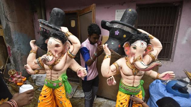 Artisans apply finishing touches to an idol of Ganesha, decorating it with faux jewellery. The festival is most commonly associated with the state of Maharashtra, while celebrations also occur widely in Tamil Nadu, Goa and Kerala. The ten day festival is also celebrated by Marathis settled in Delhi with the presence of at least two dozen Ganesh Mandals. (Raj K Raj/HT PHOTO)