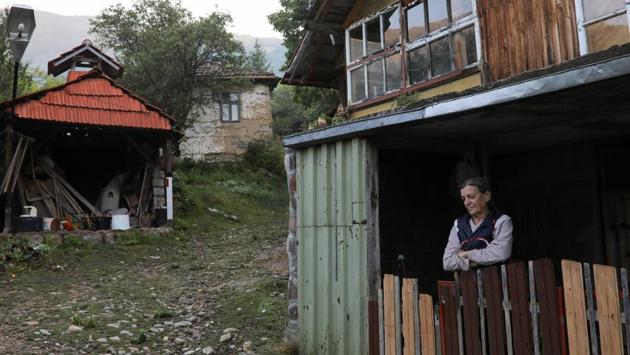 Vida, the last woman living in the village of Ravno Bucje stands in front of her home near the town of Knjazevac, Serbia. Her husband Bosko died last year and although the village is located in the interiors and has tough winters, she wants to stay back in the village. Her daughter lives in Knjazevac and brings her essentials once a month. Vida lives in the village with a dog and two cats. (Marko Djurica / REUTERS)