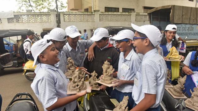 Schoolchildren share a light moment after setting a Guinness world record. (Pratham Gokhale/HT PHOTO)
