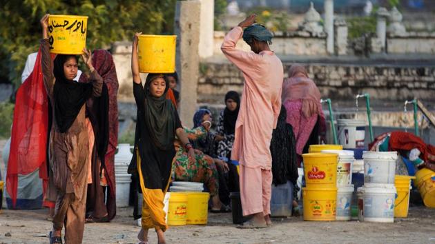 People collect water for their families from a tube well in Islamabad. A new study suggests some 50 million Pakistanis could be at risk of drinking arsenic-tainted groundwater.(AP Photo)