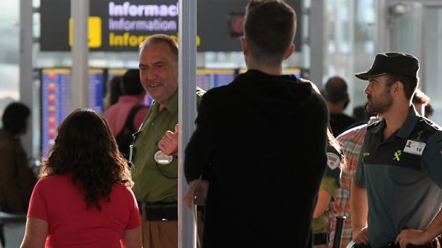 Passengers pass through a metal detector in this representational image. (AFP) Passengers pass through a metal detector in this representational image. (AFP)