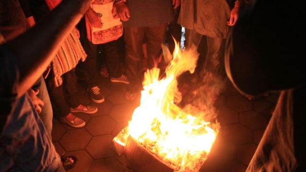 Students of the University of Hyderabad setting on fire the report of the Roopanwal Commission which exonerated university authorities and politicians named in the suicide case of Dalit student Rohith Vemula.(HT PHOTO)