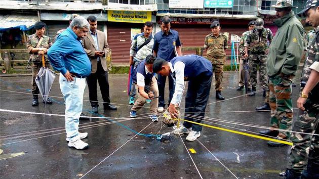 Officials investigate the blast site after an explosion near a motor-stand in Darjeeling. (PTI file) Officials investigate the blast site after an explosion near a motor-stand in Darjeeling. (PTI file)
