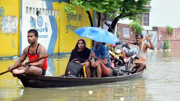 Flood-affected people commute to safer places using a boat in flood-hit Muzaffarpur district of Bihar. (PTI) Flood-affected people commute to safer places using a boat in flood-hit Muzaffarpur district of Bihar. (PTI)