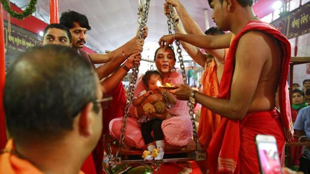 A woman and her child are weighed on a weighing scale to donate their equivalent weight in food items during Ganesh Chaturthi festival celebrations in Mumbai. Ganesh Chaturthi is believed to mark the birth anniversary of the deity and is celebrated on the fourth day (chaturthi) of the Hindu calendar month of Bhadrapada. (Rafiq Maqbool/AP) A woman and her child are weighed on a weighing scale to donate their equivalent weight in food items during Ganesh Chaturthi festival celebrations in Mumbai. Ganesh Chaturthi is believed to mark the birth anniversary of the deity and is celebrated on the fourth day (chaturthi) of the Hindu calendar month of Bhadrapada. (Rafiq Maqbool/AP)