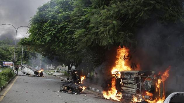 Vehicles set alight by Dera Sacha Sauda sect members burn in the streets of Panchkula. (AP)